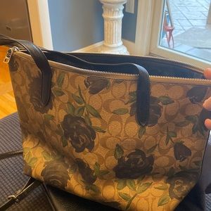 Coach bag with logo background and flowers.